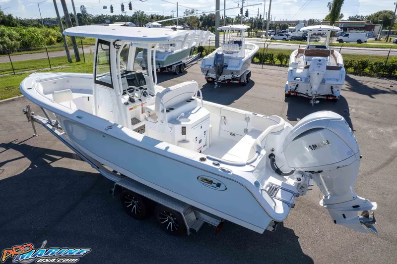 Slide: The Image of 2025 Sea Hunt Ultra 245 SE boat with Yamaha engine, displayed outdoors on a trailer. - 7