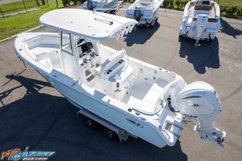 Slide: The Image of 2025 Sea Hunt Ultra 245 SE boat with Yamaha outboard engine, parked on a trailer. - 8