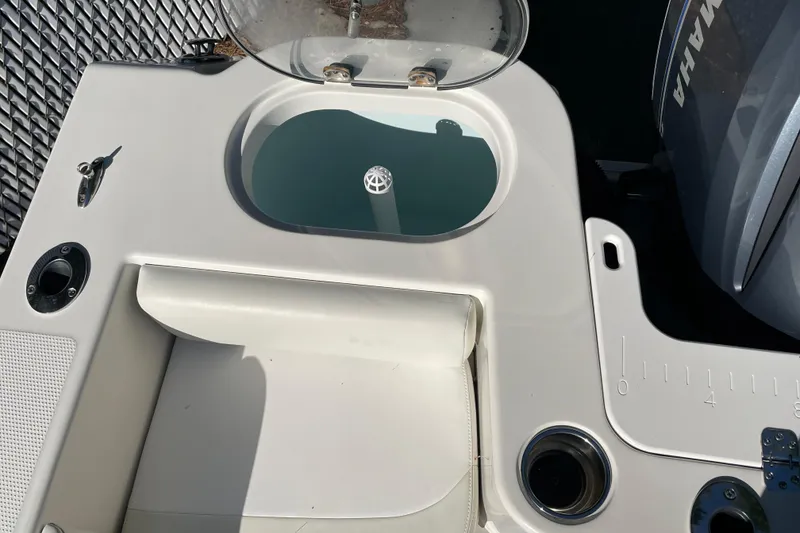 Slide: The Image of 2014 Sailfish 220 CC boat deck with livewell and Yamaha engine. - 11