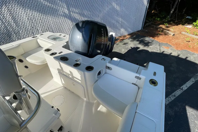 Slide: The Image of 2014 Sailfish 220 CC boat interior with Yamaha engine, featuring seating and storage compartments. - 13