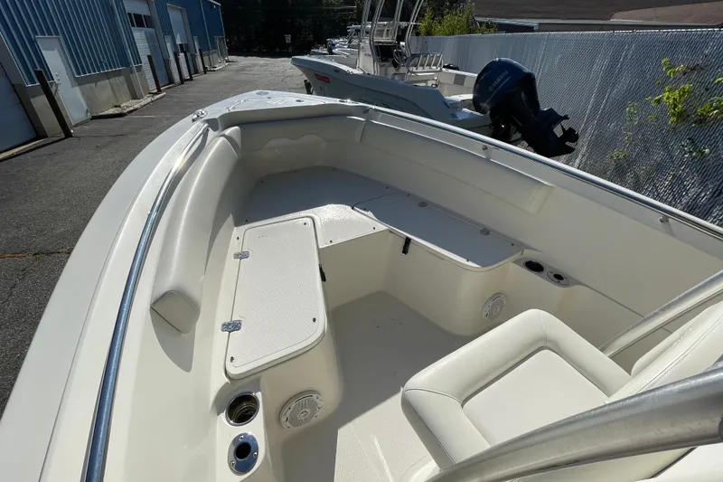 Slide: The Image of 2014 Sailfish 220 CC boat interior with seating and storage compartments. - 16