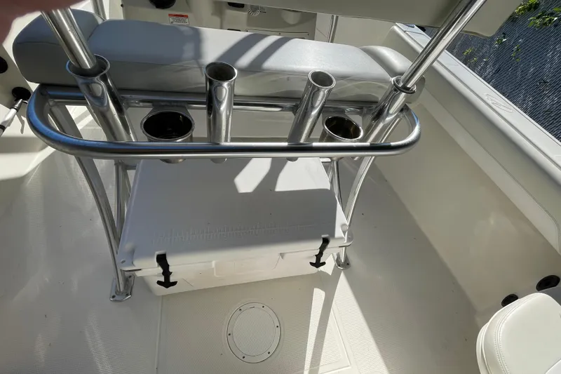 Slide: The Image of 2014 Sailfish 220 CC boat interior with rod holders and cooler storage. - 9