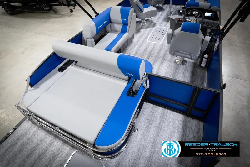 Slide: The Image of 2026 Bennington 22 SSB pontoon boat interior with blue and gray seating, showroom display. - 14