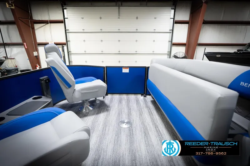 Slide: The Image of 2026 Bennington 22 SSB boat interior with blue and gray seating in showroom. - 23