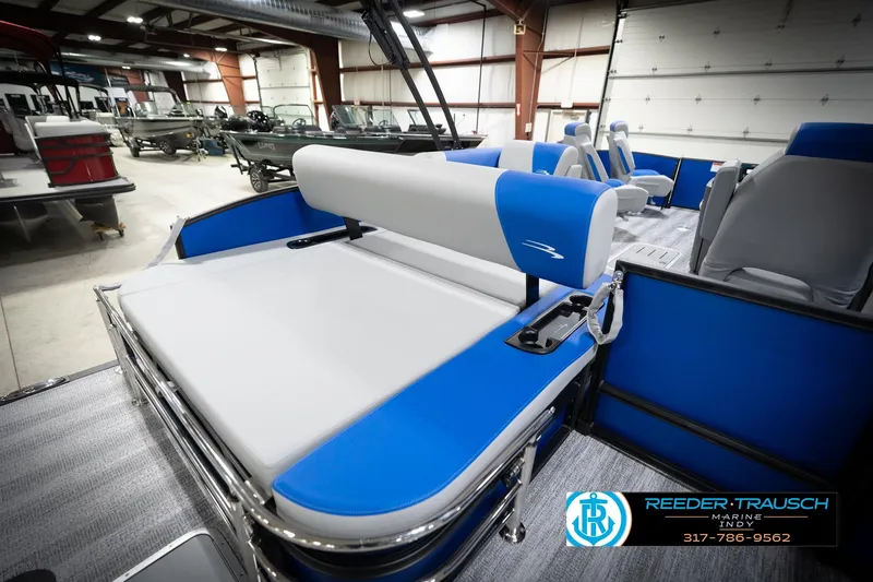 Slide: The Image of 2026 Bennington 22 SSB pontoon boat interior with blue seating in a showroom. - 31