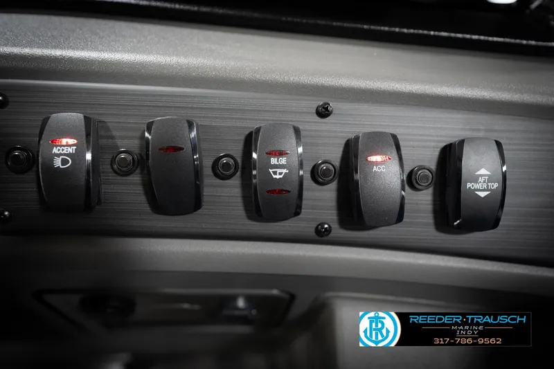 Slide: The Image of 2026 Bennington 22 SSB boat interior with blue and gray seating in showroom. - 41