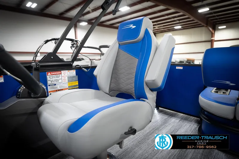 Slide: The Image of 2026 Bennington 22 SSB boat interior with blue and gray seating, Reeder-Trausch Marine logo. - 43