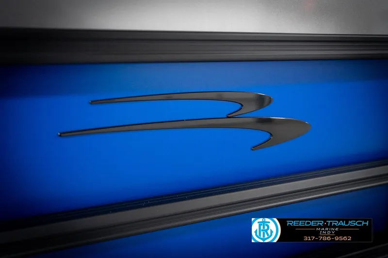 Slide: The Image of 2026 Bennington 22 SSB boat, blue exterior with "S 22" emblem, Reeder-Trausch Marine logo. - 52