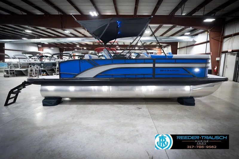 Slide: The Image of 2026 Bennington 22 SSB pontoon boat in showroom, featuring sleek design and modern amenities. - 7
