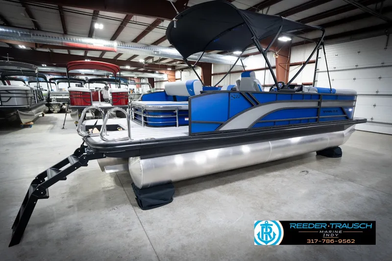 Slide: The Image of 2026 Bennington 22 SSB pontoon boat in showroom, featuring blue and silver design. - 8