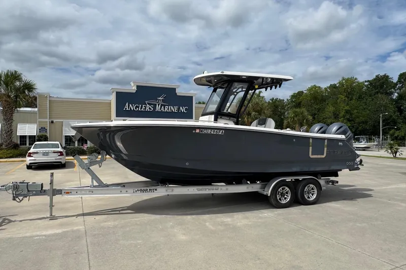 The Image of 2023 Robalo R250 Center Console boat on trailer at Anglers Marine NC dealership. - 0