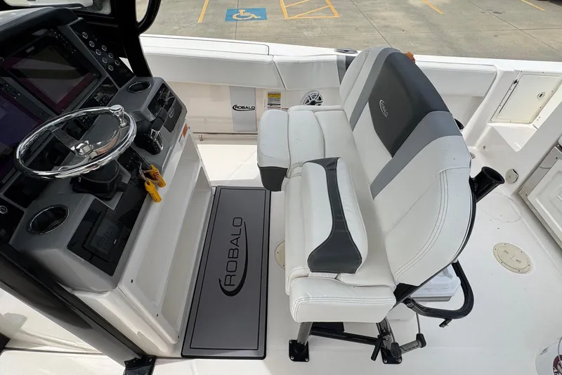 Slide: The Image of 2023 Robalo R250 Center Console boat interior with steering wheel and seating. - 14