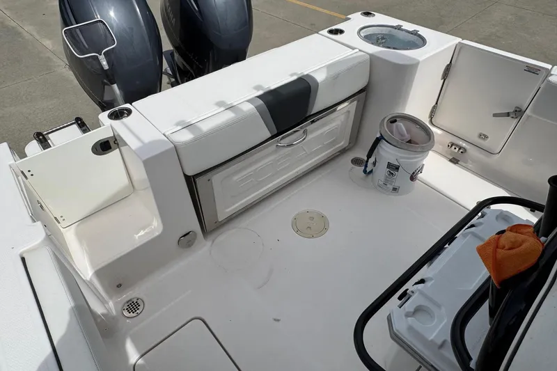Slide: The Image of 2023 Robalo R250 Center Console boat deck with storage and dual engines. - 17
