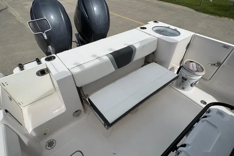 Slide: The Image of 2023 Robalo R250 Center Console boat interior with seating and dual engines. - 18