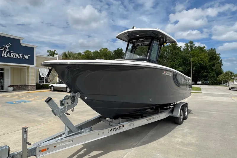 Slide: The Image of 2023 Robalo R250 Center Console boat on trailer at Marine NC dealership. - 5