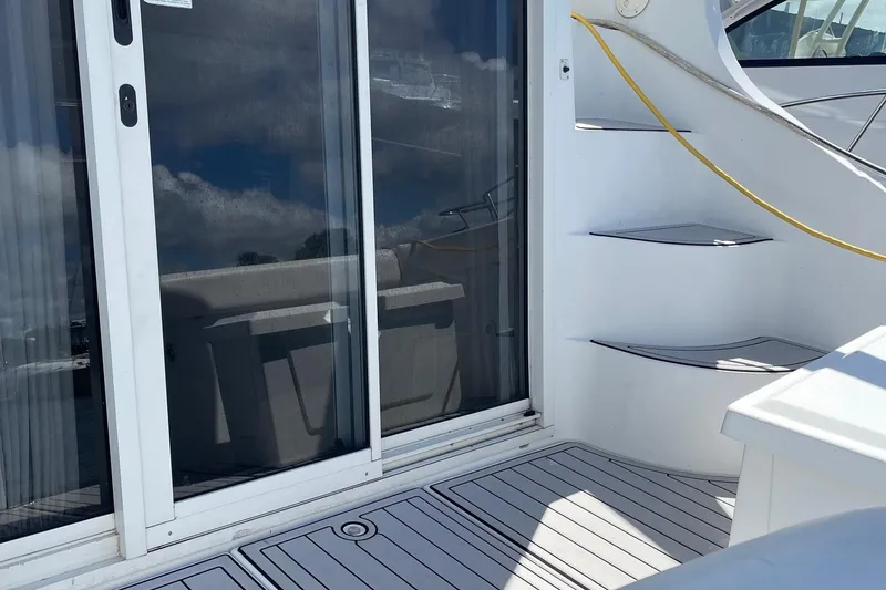 Slide: The Image of 1999 Carver Mariner 350 yacht deck with sliding glass door and curved stairs. - 5