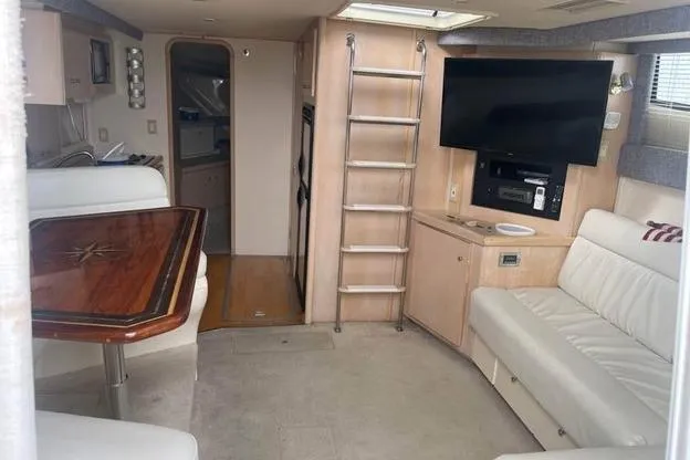Slide: The Image of Interior of 1999 Carver Mariner 350 yacht with seating, table, and entertainment system. - 8