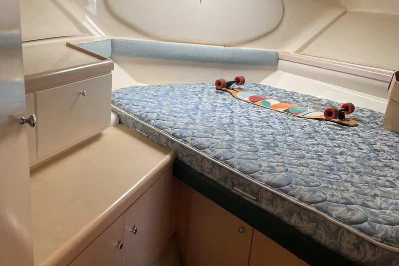 Slide: The Image of 1999 Carver Mariner 350 cabin interior with mattress and skateboard. - 14