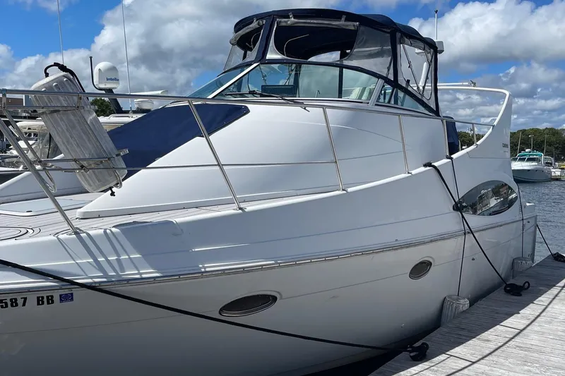 Slide: The Image of 1999 Carver Mariner 350 yacht docked at marina under blue sky. - 2