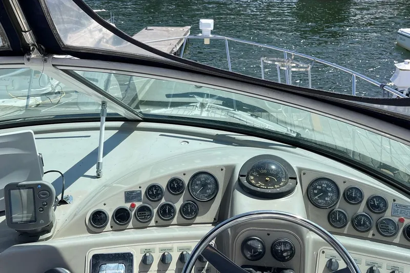Slide: The Image of 1999 Carver Mariner 350 helm with gauges and navigation equipment, overlooking water. - 4
