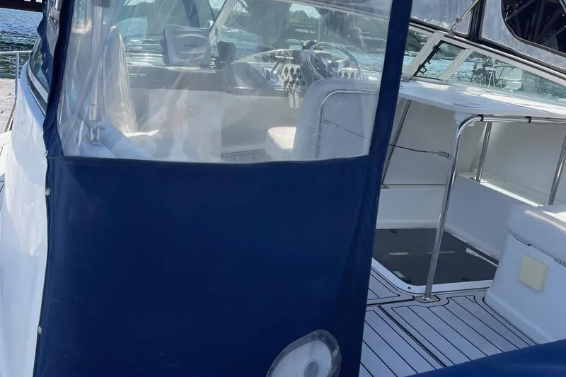 Slide: The Image of 1999 Carver Mariner 350 yacht interior with blue canopy and steering area. - 6