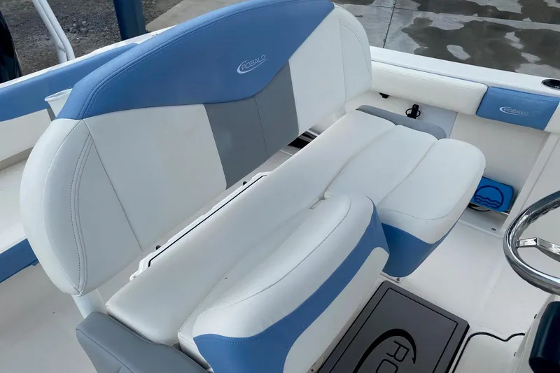 Slide: The Image of 2023 Robalo R222 Explorer boat interior with blue and white seating. - 10