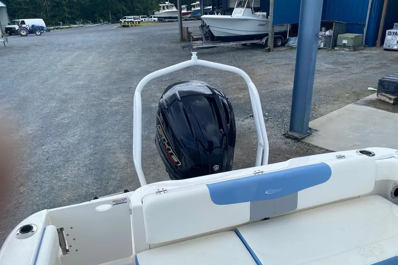 Slide: The Image of 2023 Robalo R222 Explorer boat with outboard motor in a marina setting. - 15