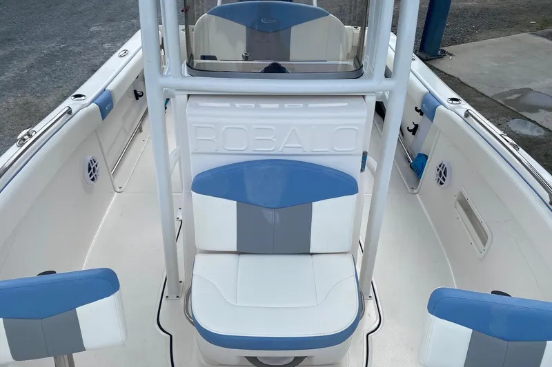 Slide: The Image of 2023 Robalo R222 Explorer boat interior with blue and white seating. - 5