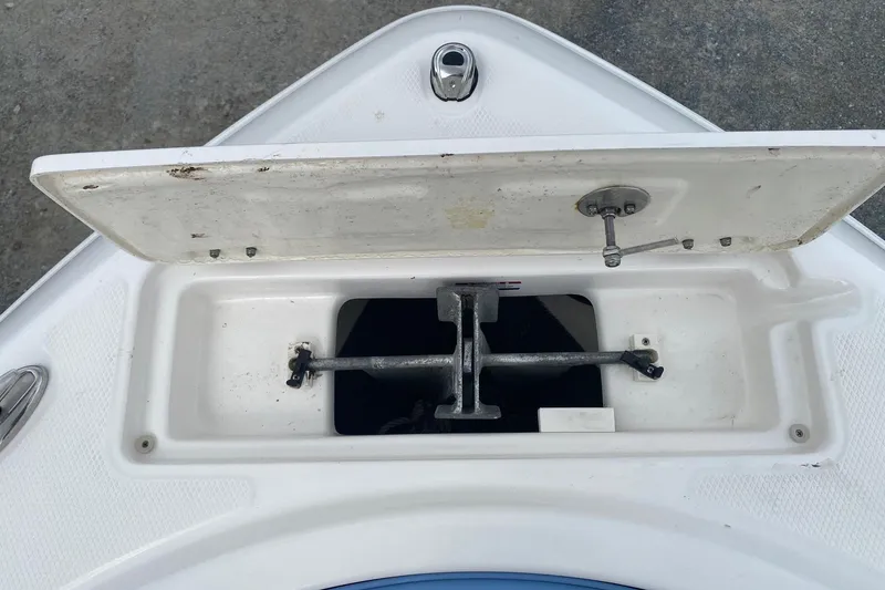 Slide: The Image of 2023 Robalo R222 Explorer anchor compartment with open hatch, showcasing storage space. - 7