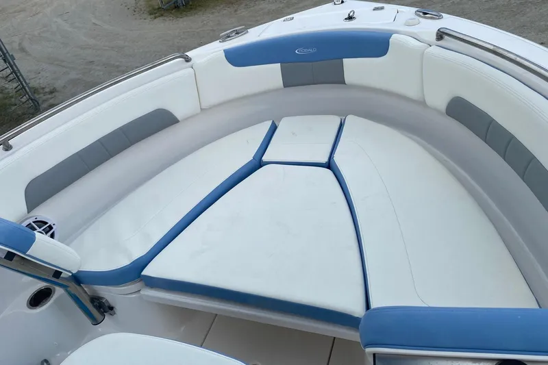 Slide: The Image of 2023 Robalo R222 Explorer boat interior with blue and white cushioned seating. - 8