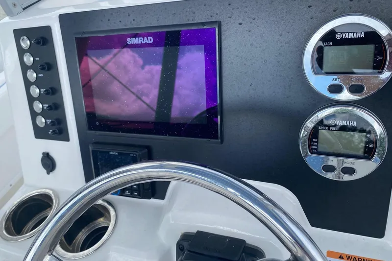 Slide: The Image of 2023 Robalo R222 Explorer dashboard with Simrad display and Yamaha gauges. - 9