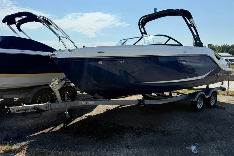 The Image of 2025 Bayliner D22I boat on trailer, sleek design, blue and white color scheme. - 0
