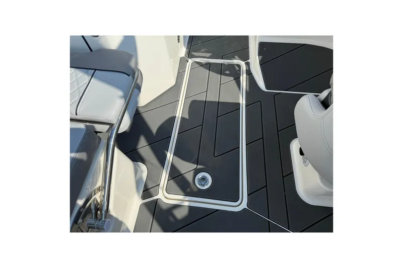 Slide: The Image of 2025 Bayliner D22I boat interior with sleek black flooring and modern seating. - 11