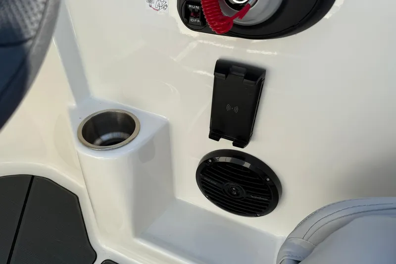 Slide: The Image of 2025 Bayliner D22I boat interior with cup holder, speaker, and phone mount. - 14