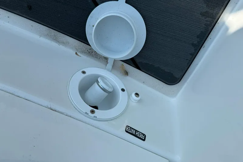 Slide: The Image of Bayliner D22I 2025 boat's fresh water fill port with open cap. - 15