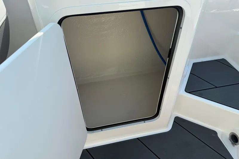 Slide: The Image of Open storage compartment on 2025 Bayliner D22I boat, featuring sleek design and modern finish. - 17