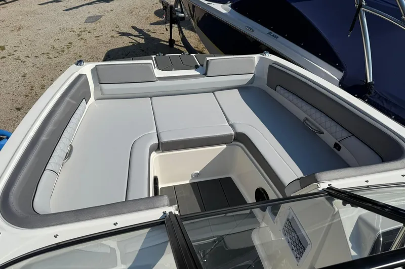 Slide: The Image of 2025 Bayliner D22I boat interior with gray seating and storage compartments. - 21