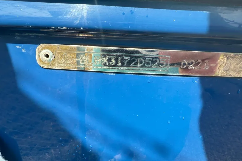 Slide: The Image of 2025 Bayliner D22I boat identification plate on blue hull. - 23