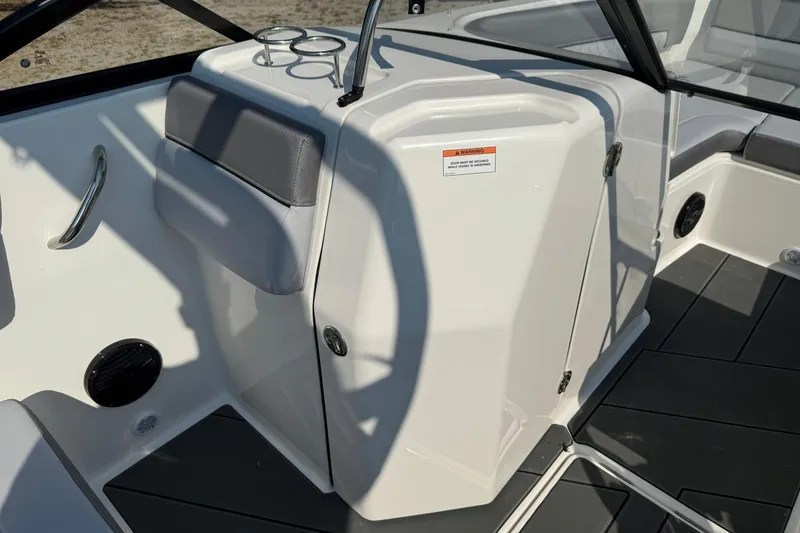 Slide: The Image of 2025 Bayliner D22I boat interior with seating, cup holders, and storage compartment. - 4