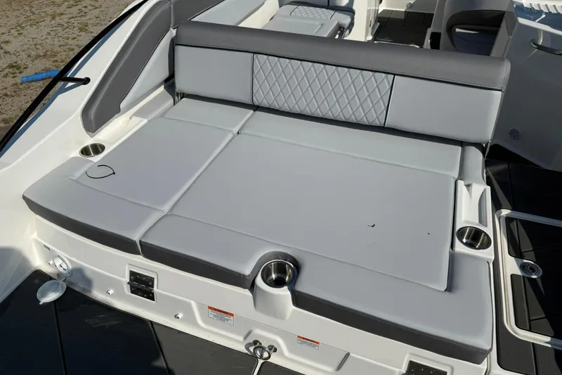 Slide: The Image of 2025 Bayliner D22I boat interior with cushioned seating and cup holders. - 9