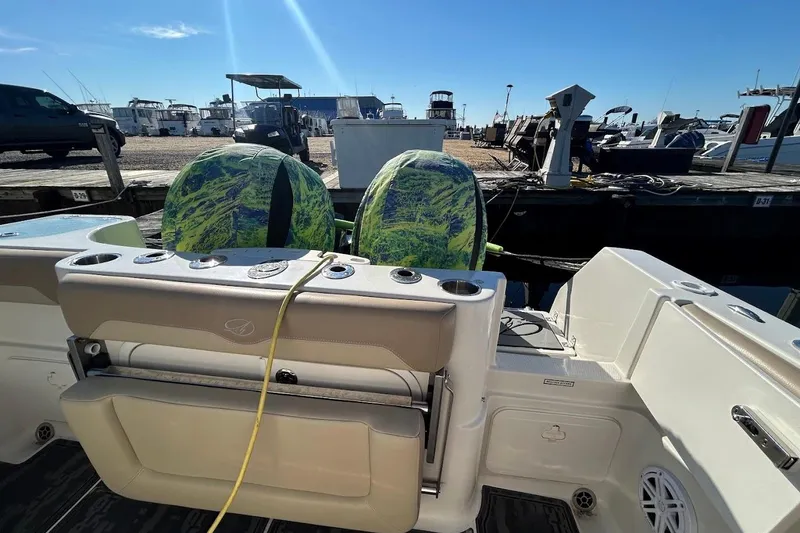 Slide: The Image of 2019 Sailfish 270 CC boat with dual engines at a marina dock. - 10