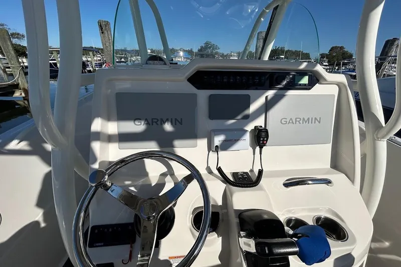 Slide: The Image of 2019 Sailfish 270 CC boat dashboard with Garmin navigation system and steering wheel. - 15
