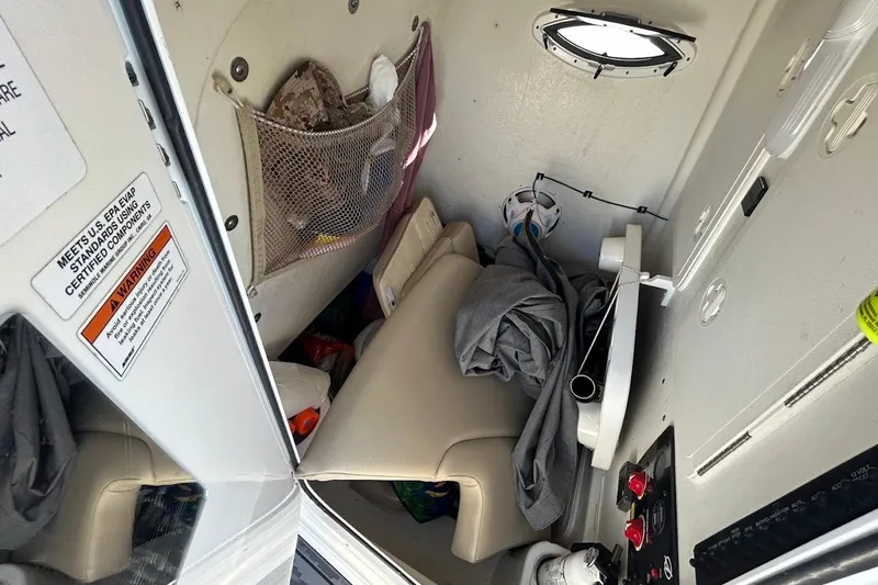 Slide: The Image of Interior of a 2019 Sailfish 270 CC boat cabin with storage and seating. - 16