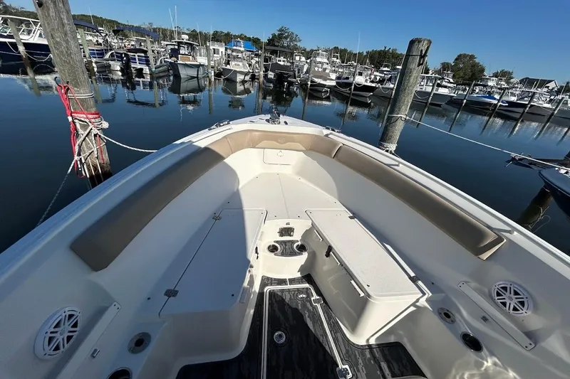 Slide: The Image of 2019 Sailfish 270 CC boat docked in a marina, showcasing spacious seating and storage. - 18