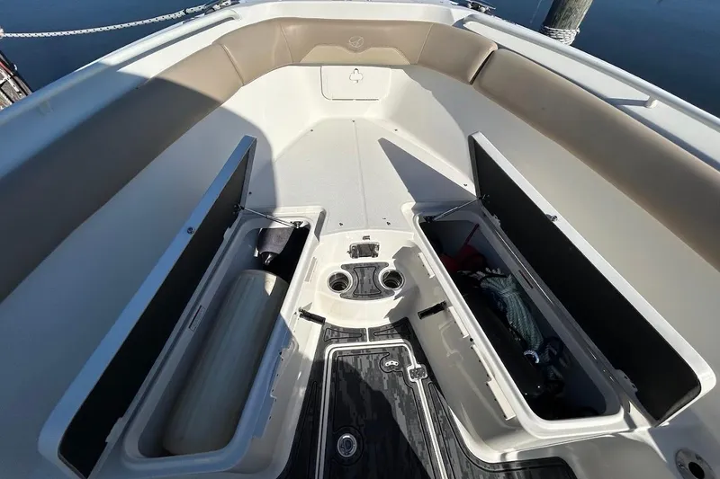 Slide: The Image of 2019 Sailfish 270 CC boat interior with open storage compartments and cushioned seating. - 19