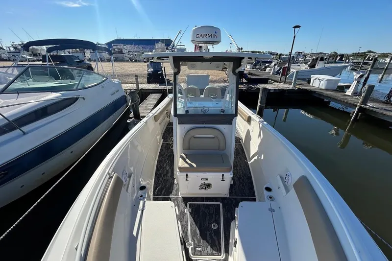 Slide: The Image of 2019 Sailfish 270 CC boat docked at marina, featuring Garmin equipment. - 22