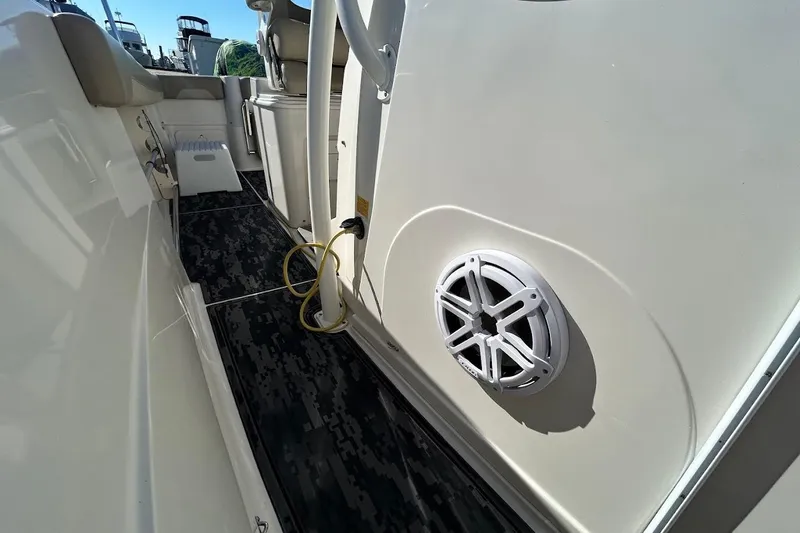 Slide: The Image of 2019 Sailfish 270 CC boat interior with speaker and seating area. - 24
