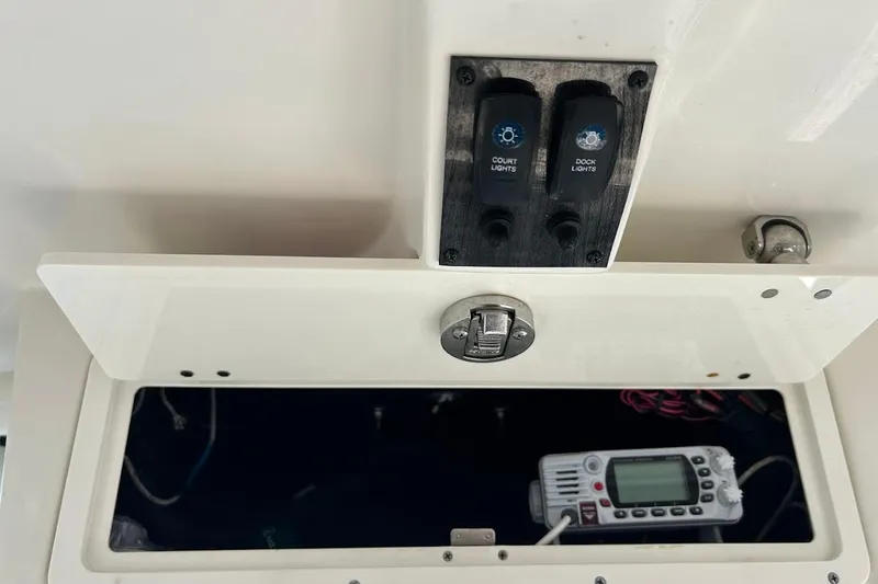 Slide: The Image of 2019 Sailfish 270 CC boat controls with switches and radio compartment. - 27