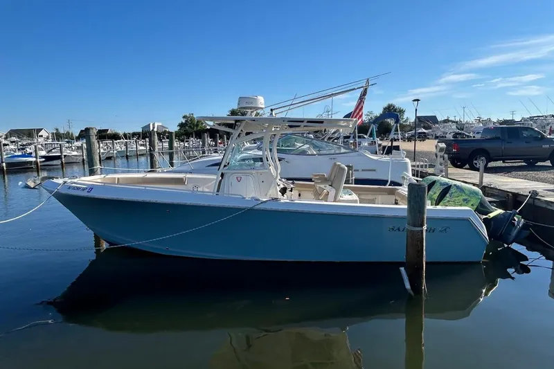 Slide: The Image of 2019 Sailfish 270 CC boat docked in a marina under clear blue skies. - 5