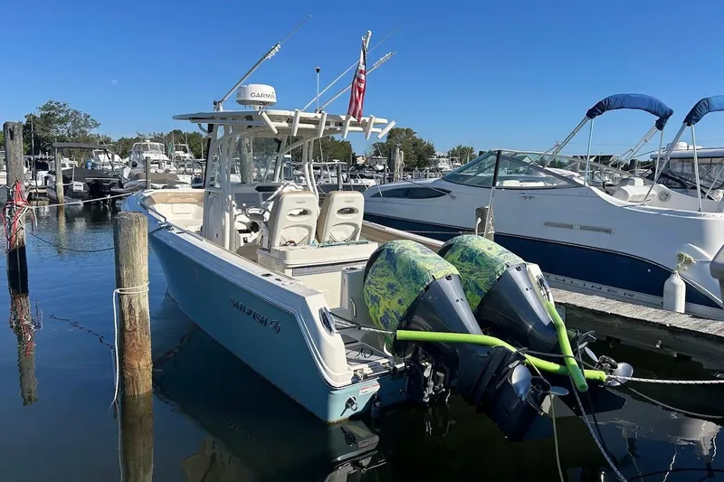 Slide: The Image of 2019 Sailfish 270 CC boat docked with twin outboard motors. - 6